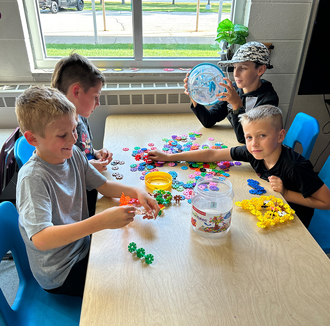 Kids playing at an activity table.