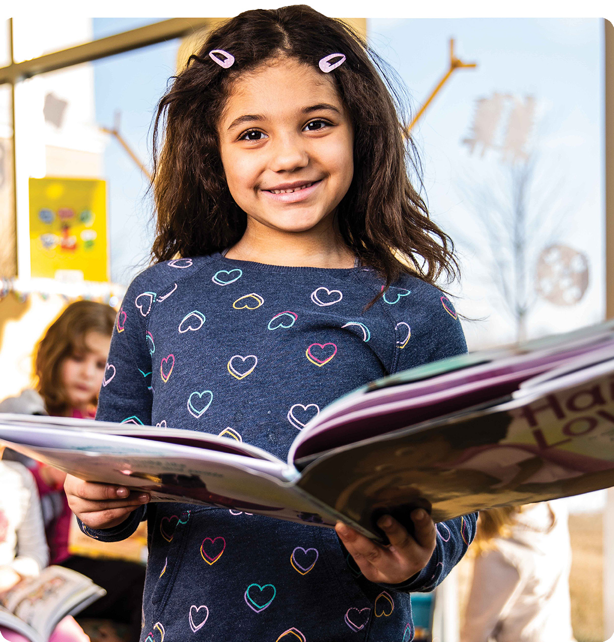 Girl holding a book.