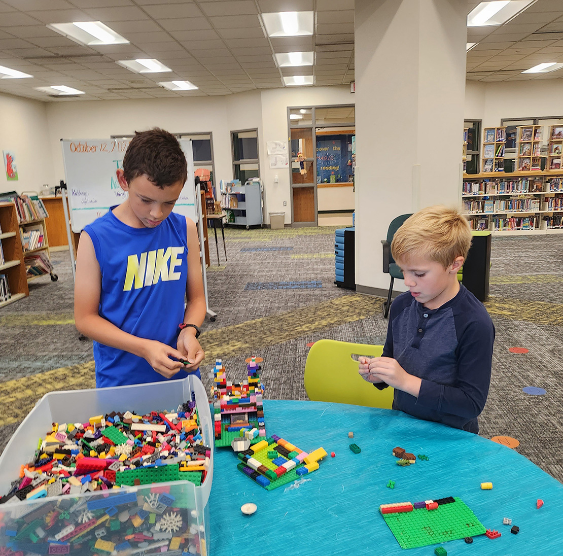 Two kids playing with legos