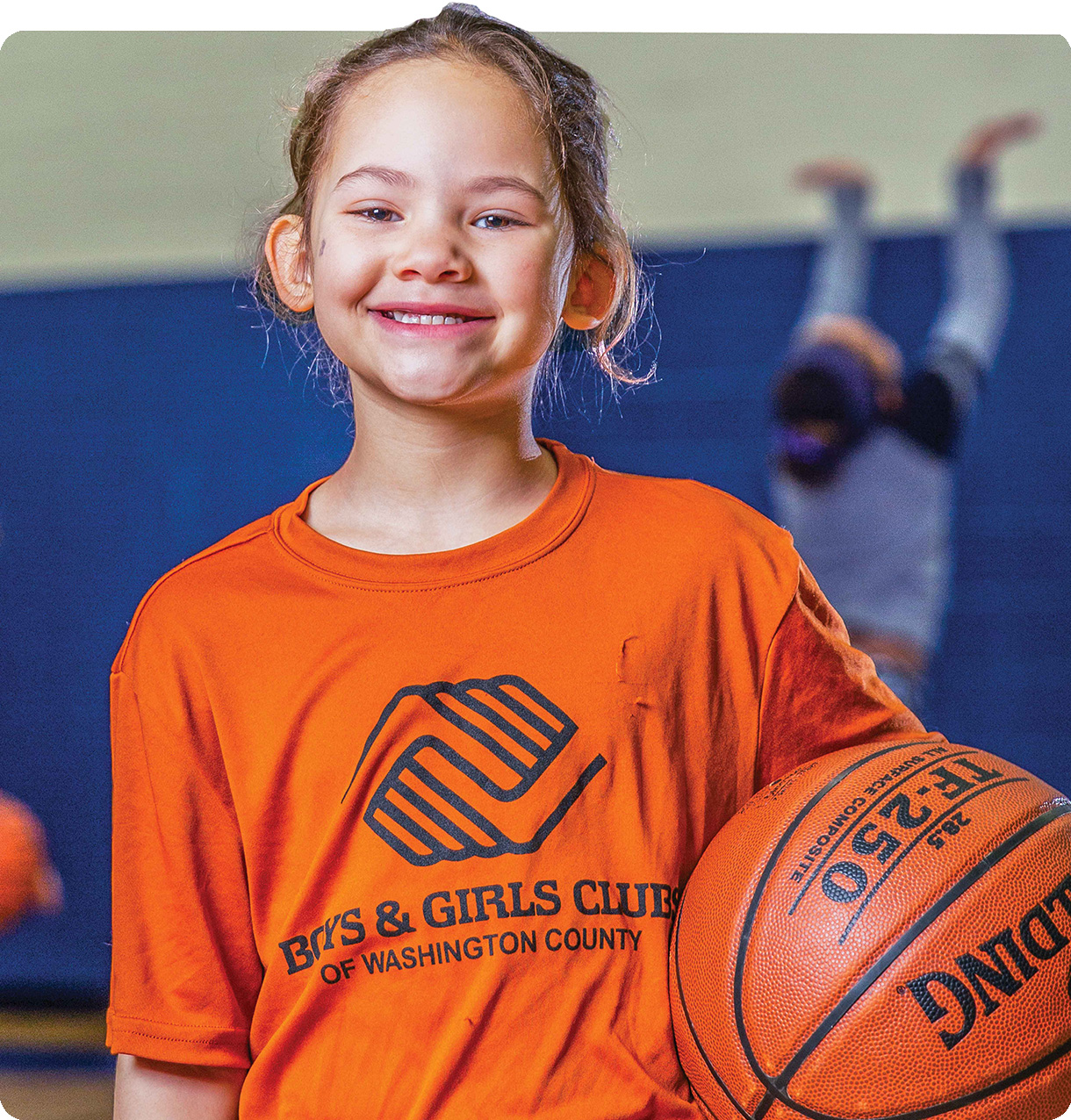 Girl holding a basketball.