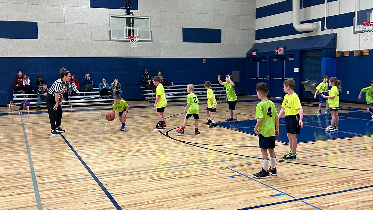 Kids on a basketball court.