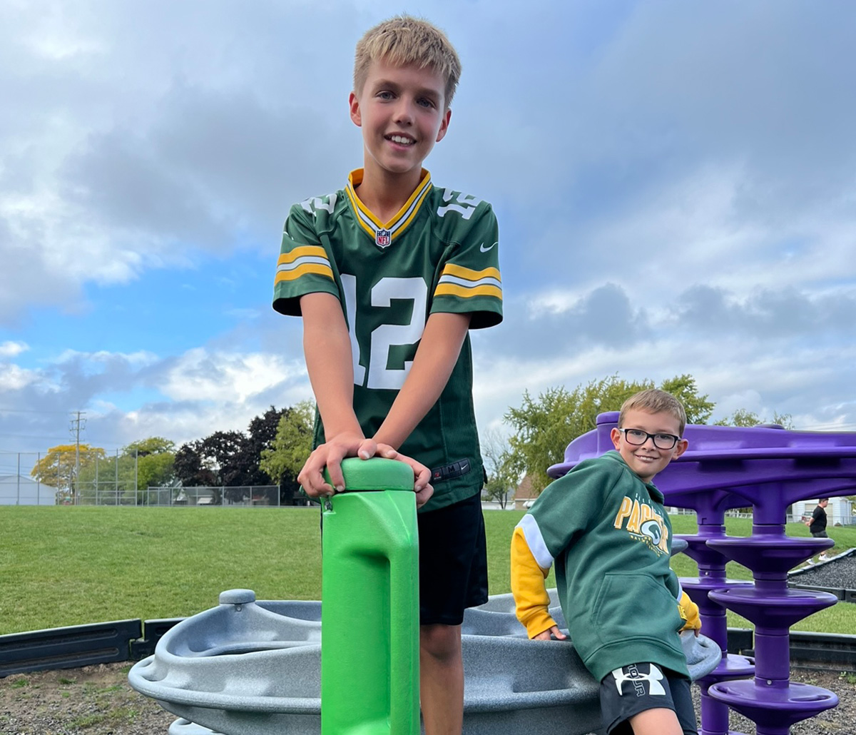 Boys playing on playground equipment.